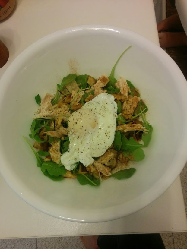 Breakfast "hash" with sweet potato, arugula, roast chicken, walnuts, cinnamon, olive oil, salt, and pepper topped with a poached egg.
